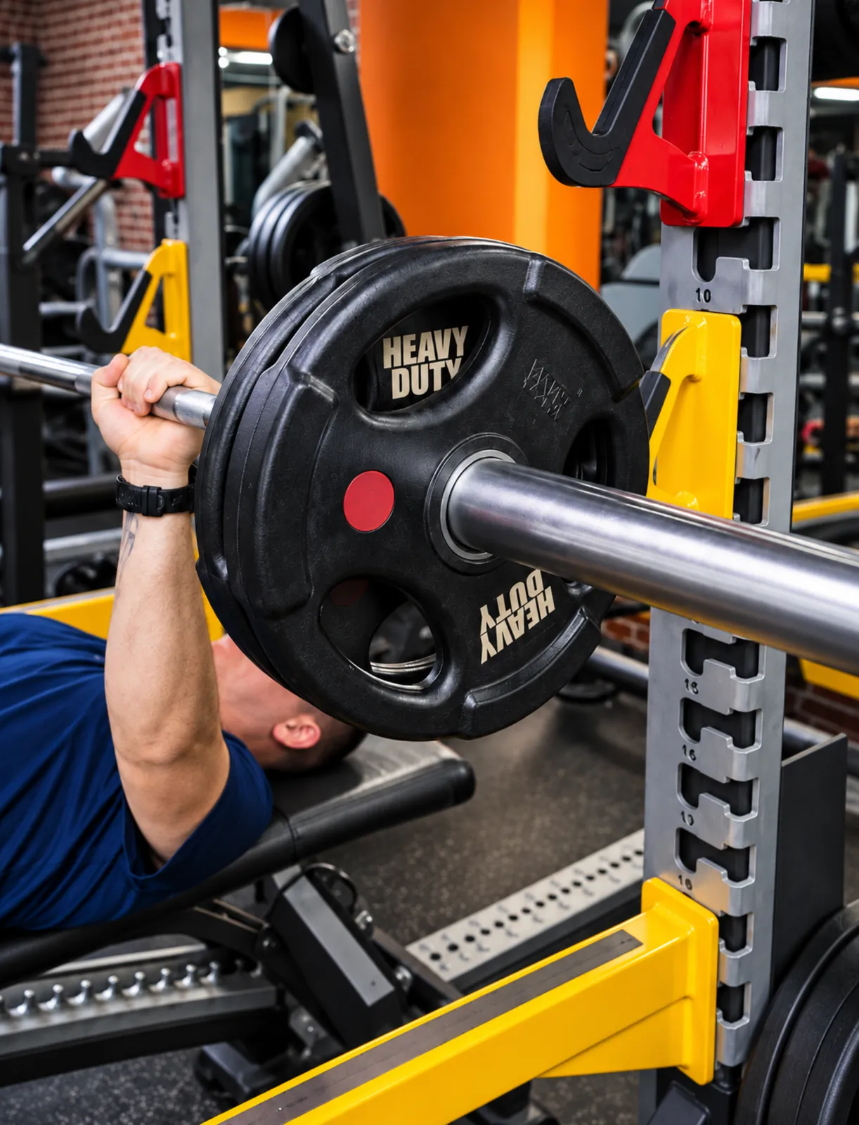 Un adhérent au développé couché avec une barre, dans l’espace musculation du centre Platinium Training